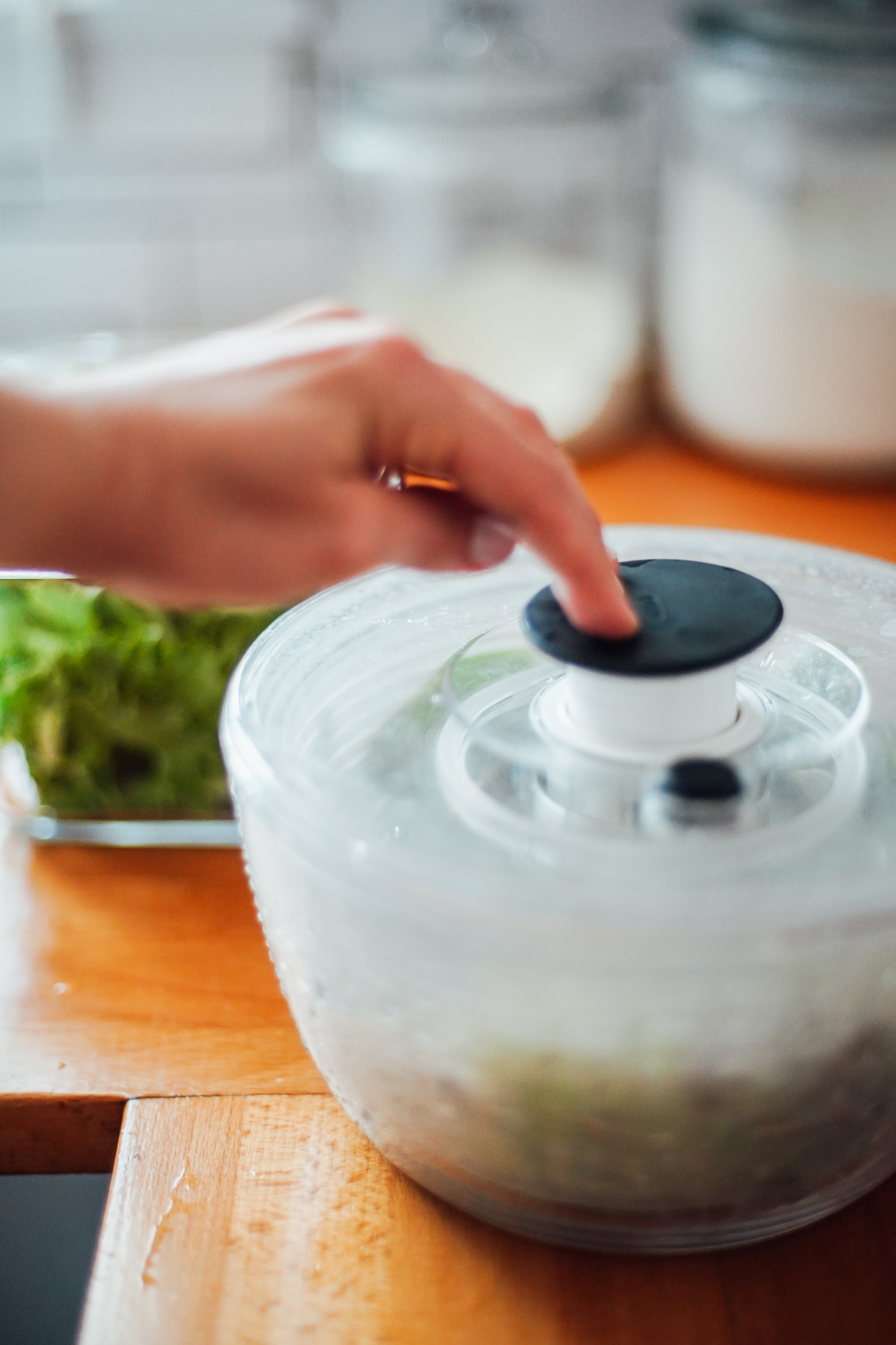 Drying cilantro in a salad spinner on the kitchen counter.