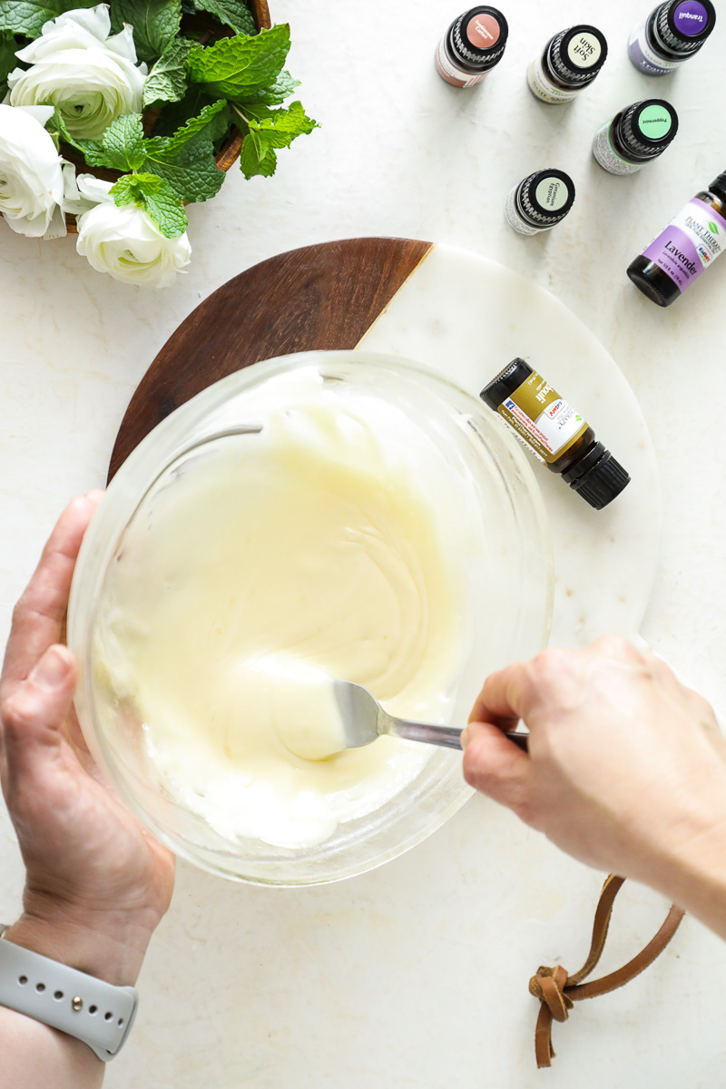 Using a fork to whip the body butter to make cream.